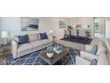 Cozy living room featuring stylish decor, a comfortable sofa, and a dining area with modern furnishings at 1230 Americana Pl, Orlando, FL 32807
