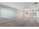 Spacious living room with lots of neutral paint and carpet at 1230 Americana Pl, Orlando, FL 32807
