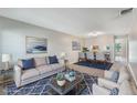 Inviting living room with stylish decor, a comfortable sofa, and an open dining area at 1230 Americana Pl, Orlando, FL 32807