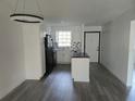 Bright kitchen with white cabinets, black appliances, and island at 1250 S Denning Dr # 108, Winter Park, FL 32789