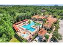 Gorgeous resort style pool with cabanas, a splash pad, lounge chairs, and lush tropical landscaping at 1375 Tuscana Ln # 1102, Davenport, FL 33896