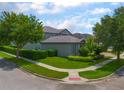 Attractive corner lot features lush landscaping, mature trees, and a well-maintained lawn at 14357 United Colonies Dr, Winter Garden, FL 34787