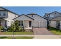 Charming single-story home featuring a cozy front porch, two-car garage, and beautifully landscaped front yard at 16055 Silver Brook Way, Winter Garden, FL 34787