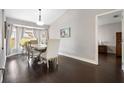 Bright dining room with hardwood floors, stylish furniture, and natural light from bay window at 1616 Golden Poppy Ct, Orlando, FL 32824