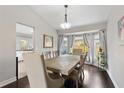 Bright dining room with hardwood floors, stylish furniture, and natural light from bay window at 1616 Golden Poppy Ct, Orlando, FL 32824