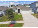 Inviting one-story home boasting a lush green lawn and a convenient driveway to the garage at 1791 Hackberry St, Clermont, FL 34715