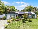 Charming single-story home featuring a well-manicured lawn and solar panels for energy efficiency at 1872 Wayside Dr, Orlando, FL 32818