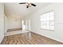 Large living room area featuring hardwood flooring, neutral walls, and lots of natural lighting at 1947 Vienna Ave, Deltona, FL 32725