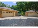 Spacious brick garages, providing ample parking on the paver driveway at 2009 Woody Dr, Windermere, FL 34786
