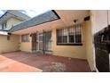 The back patio features secure iron bars, a sliding door, and a partially exposed red concrete area at 2235 Silver Pines Pl # 401, Orlando, FL 32808
