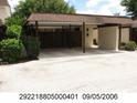 Residential property with a carport providing covered parking spaces and landscaped greenery at 2235 Silver Pines Pl # 401, Orlando, FL 32808