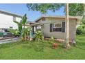 Charming single-story home showcasing well-maintained lawn and mature landscaping at 232 E Grant St, Orlando, FL 32806