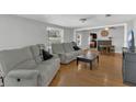 Inviting living room with hardwood floors and modern furnishings, open to dining area at 232 E Grant St, Orlando, FL 32806
