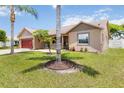 Inviting single-story home boasts a lush green lawn and beautiful landscaping at 2407 Accord Ter, Kissimmee, FL 34758