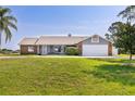 Charming single-story home features a well-manicured lawn and attached two-car garage at 2562 Sheffield Dr, Deltona, FL 32738