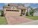 Charming home with brick driveway, two car garage, and well maintained landscaping at 2598 Trielle Ave, Kissimmee, FL 34741