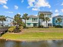 Scenic view of colorful homes with palm trees lining a waterfront property on a sunny day at 3020 Parrot Head Pl, Kissimmee, FL 34747
