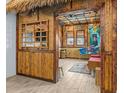 Unique recreation room with tiki bar decor, bamboo accents, thatched roof, and a tropical ambiance at 3020 Parrot Head Pl, Kissimmee, FL 34747