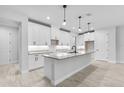 Stylish kitchen featuring white cabinets, granite countertops, stainless steel appliances and a large center island at 30369 Apricot Ave, Eustis, FL 32736