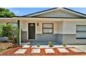 Inviting front entrance with stone walkway, manicured garden, and fresh exterior paint at 3397 Janet St, Apopka, FL 32712