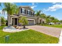 Charming two-story home with brick driveway, lush green lawn, and well-maintained landscaping at 3883 Crawley Down Loop, Sanford, FL 32773