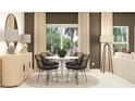 Dining area with a round table, chairs, and a large window providing natural light at 415 Puma Loop, Groveland, FL 34736