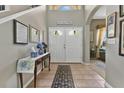 Elegant foyer with tile flooring, a decorative table, and a view into the living spaces, creating a grand entrance at 4221 Kezar Ct, Belle Isle, FL 32812