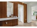 Stylish entryway featuring wood accents, a mirror, and a glimpse into the modern kitchen at 4310 Lana Ave, Davenport, FL 33897
