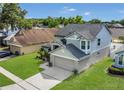 An aerial view of a two-story house showing the surrounding neighborhood and green spaces at 485 Whittingham Pl, Lake Mary, FL 32746