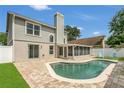Inviting backyard with a private pool, brick patio, and screened-in lanai, perfect for relaxation at 485 Whittingham Pl, Lake Mary, FL 32746