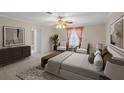 Relaxing bedroom featuring a neutral palette, sitting area, and ensuite access at 4895 Cr 134B, Wildwood, FL 34785
