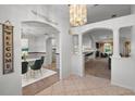 Bright open foyer featuring arched doorways, tile accents, and views to the living spaces at 4895 Cr 134B, Wildwood, FL 34785