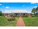 Beautiful brick home with well-manicured landscaping, front porch and walkway at 4895 Cr 134B, Wildwood, FL 34785
