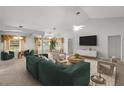 Spacious living room with neutral carpet, large windows, and comfortable seating arrangement at 4895 Cr 134B, Wildwood, FL 34785
