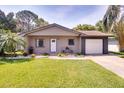 A charming single-Gathering home with a well-kept lawn, inviting landscaping, and a cozy front entry at 5216 Sunrise Blvd, Orlando, FL 32803