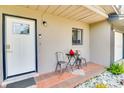 Cozy front porch with a seating area, a decorative cardinal, and a view of the front yard at 5216 Sunrise Blvd, Orlando, FL 32803