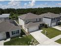 Two-story home features an attached two-car garage and manicured front lawn at 5350 Pine Lilly Dr, St Cloud, FL 34771