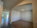 Open living area featuring tile floors and a decorative archway into carpeted room at 5350 Pine Lilly Dr, St Cloud, FL 34771