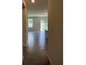 Bright, open-concept living room with tile floors and sliding glass doors leading to the outside at 5350 Pine Lilly Dr, St Cloud, FL 34771