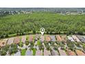 Stunning aerial view of the neighborhood showcasing lush greenery and a peaceful creek bordering the backyard at 636 Grand Canal Dr, Kissimmee, FL 34759