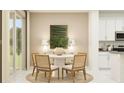 Cozy dining area with a round table, four chairs, and sliding glass doors for natural light at 773 Tundra Loop, Groveland, FL 34736