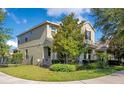 Charming two-story home featuring a lush green lawn, landscaped garden, and a welcoming front porch at 8256 Bayview Crossing Dr, Winter Garden, FL 34787