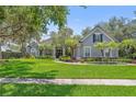 Well-maintained single-Gathering home featuring mature trees and beautifully landscaped front yard at 8612 Summerville Pl, Orlando, FL 32819