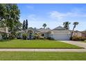 Inviting home with lush green lawn, beautiful landscaping, and classic architectural details at 1107 Almond Tree Cir, Orlando, FL 32835