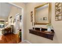 Hallway features wood floors, decorative accents, and a view into the living room at 1146 Villa Ln # 101, Apopka, FL 32712