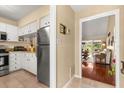 View of the kitchen with stainless steel appliances and white cabinetry, seamlessly connected to the living area at 1146 Villa Ln # 101, Apopka, FL 32712