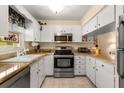 Well-lit kitchen featuring stainless steel appliances and granite countertops at 1146 Villa Ln # 101, Apopka, FL 32712