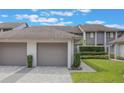 Inviting townhouse featuring attached garages, well-kept landscaping, and a serene neighborhood setting at 148 Olive Tree Cir # 148, Altamonte Springs, FL 32714