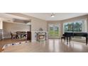 Bright living room with fireplace, a piano and beautiful flooring and dining area at 148 Olive Tree Cir # 148, Altamonte Springs, FL 32714