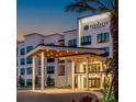 Elegant building exterior featuring covered entryway and illuminated signage: The Terraces at The Grove Resort at 15695 Grove Resort Ave # 4308, Winter Garden, FL 34787
